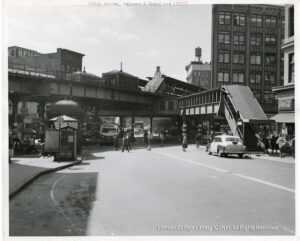 Image of a road with cars, buses, taxi,s and the Third Avenue El, as well as a subway station for the 2 and 5 lines.