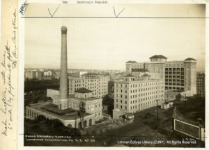 Image of several buildings, with a smokestack for the hospital laundry.