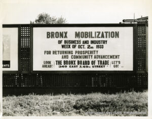 Image of a billboard saying "Bronx Mobilization of Business and Industry, week of October 2, 1933, for returning prosperity and community advancement. Look ahead! Let's Go! Bronx Board of Trade, 349 East 149th Street