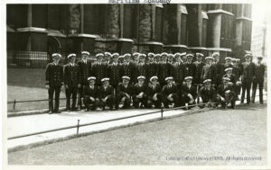 Image of about 30 men in formal navaluniforms looking at the camera.