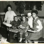 Image of a Santa with three children and one older woman.