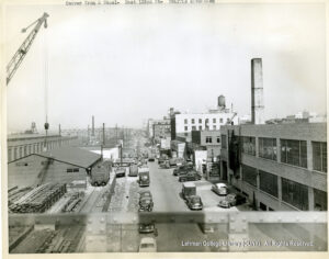 Image of cars, trucks, and factories.