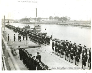 Image of soldiers lined facing a gangplank.