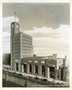 Image of Dollar Savings bank building, as well as several cars