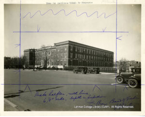 Image of a large three story building and circa 1920s cars.