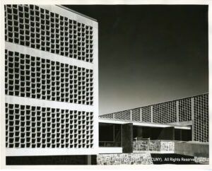 Image of modernist building whose facade looks like square honeycombs.