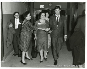 Image of Jerry Lewis in a blazer with several women in dresses and one man in a suit.