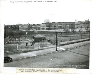 Image of a playground with athletic fields, swings, and a comfort station. Housing is visible in the distance.