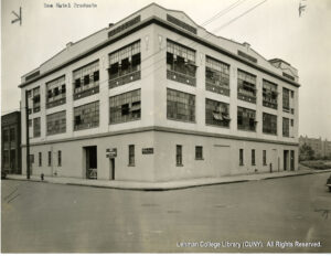 Image of a factory building with several open windows.