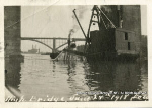 Image of a barge being sunk. Washington Bridge and smoke stacks are visible.