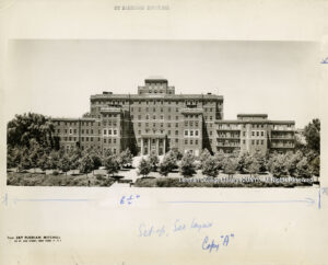 Image of a hospital building. Many trees are in front. Photo is credited to Jay Florian Mitchell of 56 W. 45th St, New York, NY