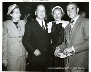 Image of a woman and man in suits, a woman in a dress, and Mickey mantle in a suit.