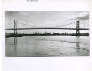 Image of a bridge. Manhattan is visible in the background.