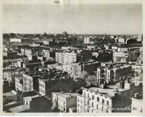 Image of housing and vactories. Several vacant lots are also visible.