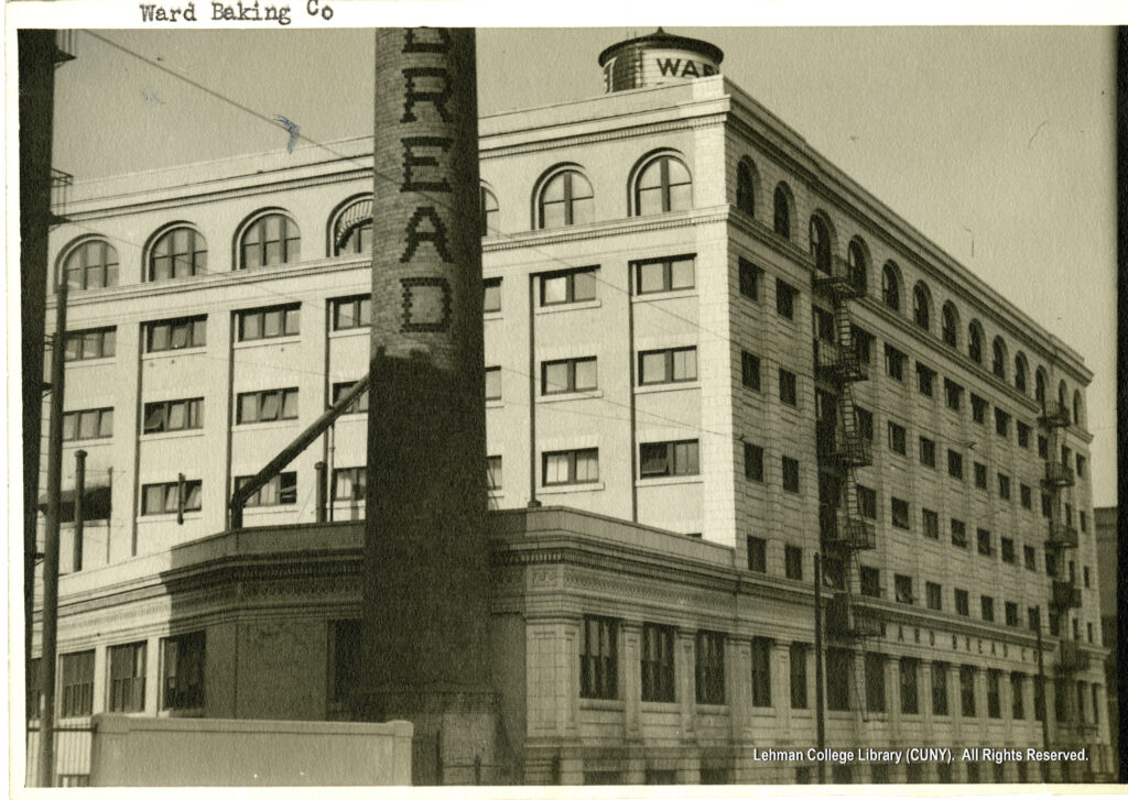 Image of a factory building with a water tower on top saying Ward and a smokestack saying "bread."