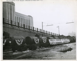 Image of a train with flags saying "Largest Trainload of Wines in History; Chateau Martin Winery of California"