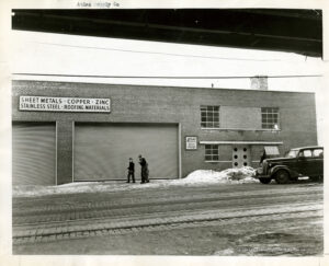 Image of a closed garage with people walking past