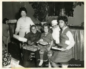 Image of a Santa with three children and one older woman.