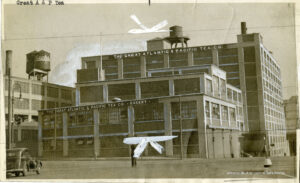 Image of a factory saying "The Great Atlantic & Pacific Tea Co. and Bakery." A watertower for "Sachs" is nearby.