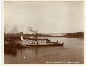 Image of a large ferry boat and a small tug boat on a river. The ferry boat has a sign saying "Express"